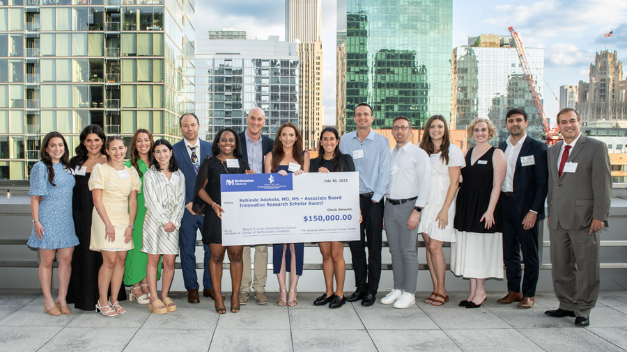 Associate Board group photo, holding a giant check