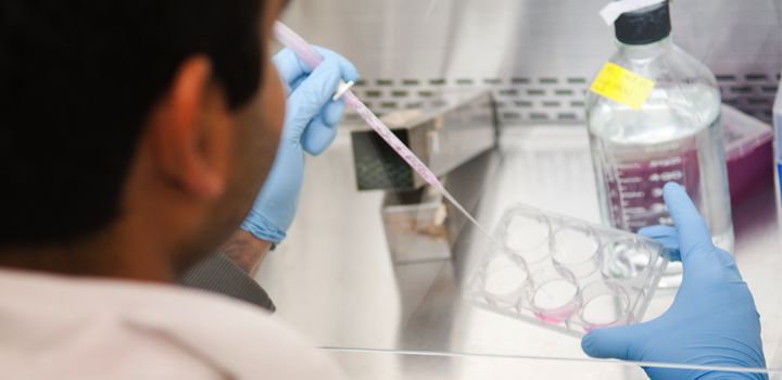 Researcher using a pipette