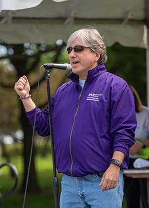 Dr Platanias speaks at a microphone in Grant Park