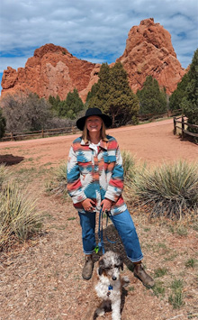 Cancer survivor Megan with her dog on a hike