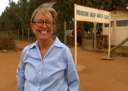 Ann Lurie in Africa, standing outside besides a clinic building