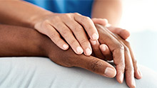 Someone places their hand over another's hand.