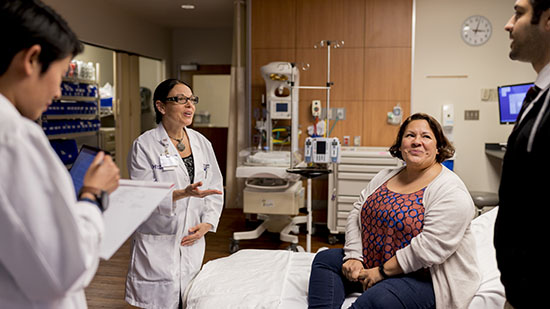 Doctor speaks with patient in clinic