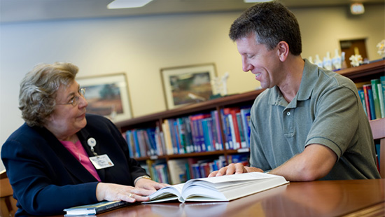 Staff with patient in the library