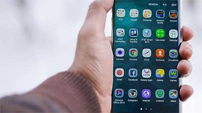 hand holding cell phone with icons displayed