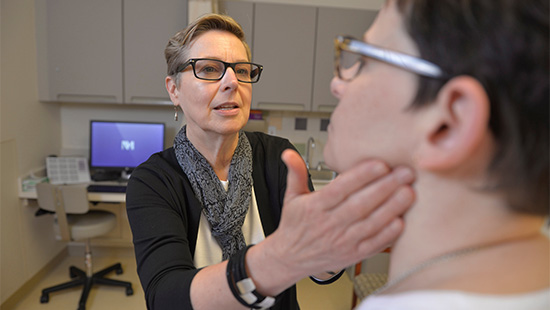 Healthcare professional checking patient lymph nodes