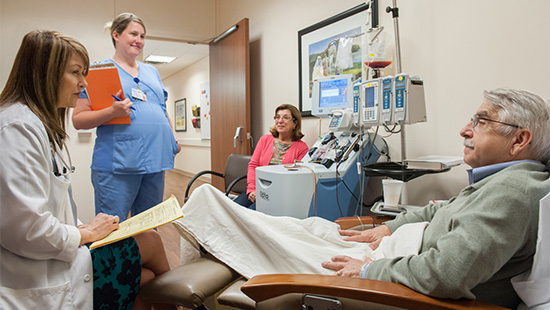 Healthcare professionals meeting with patient and family in clinic